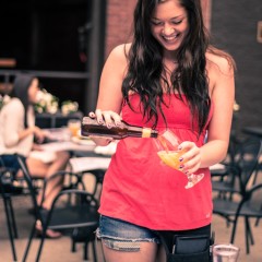 portrait of waitress pouring craft beer on Chicago restaurant patio